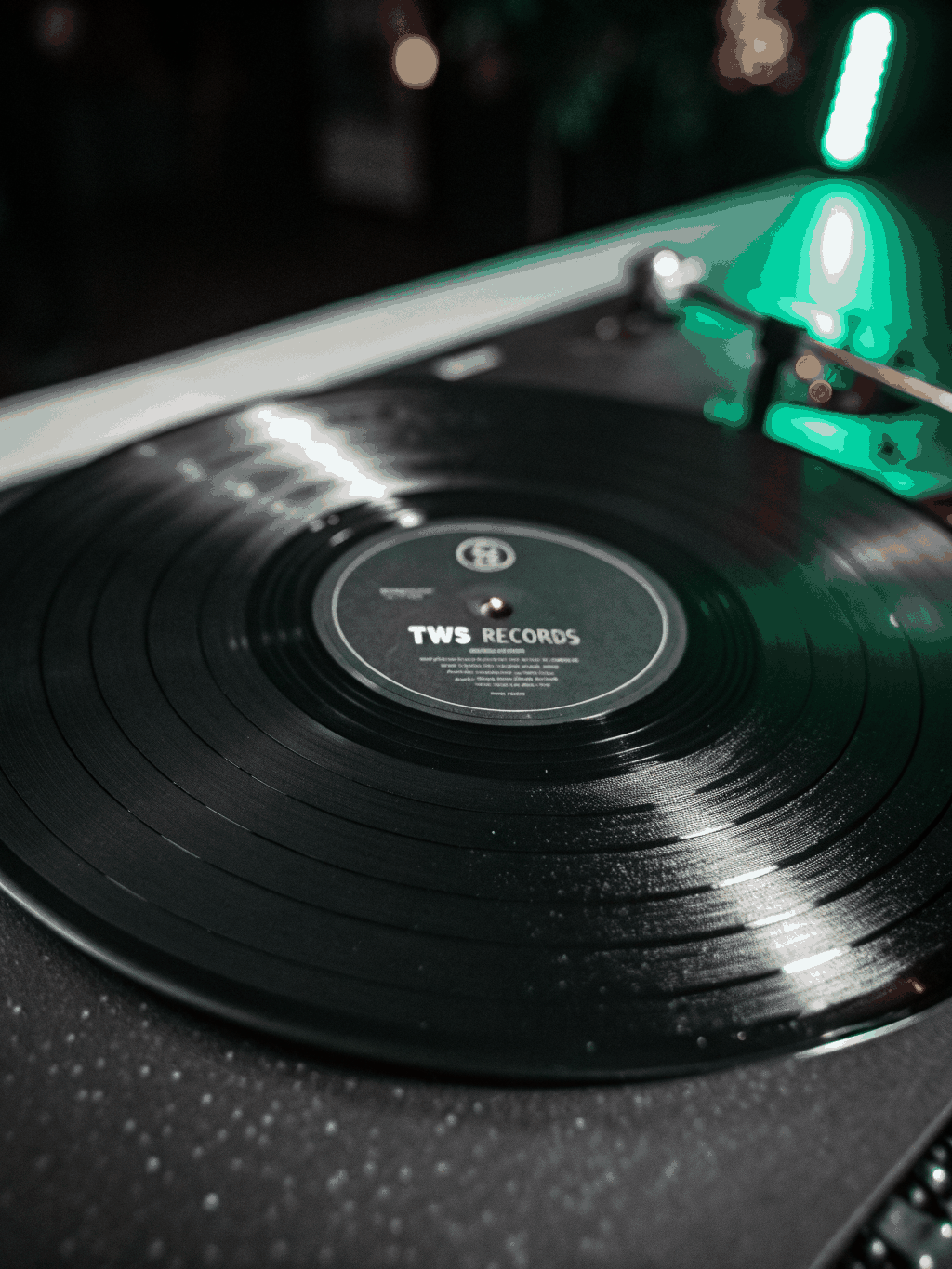 Macro shot of vinyl record grooves reflecting light in a monochromatic setting